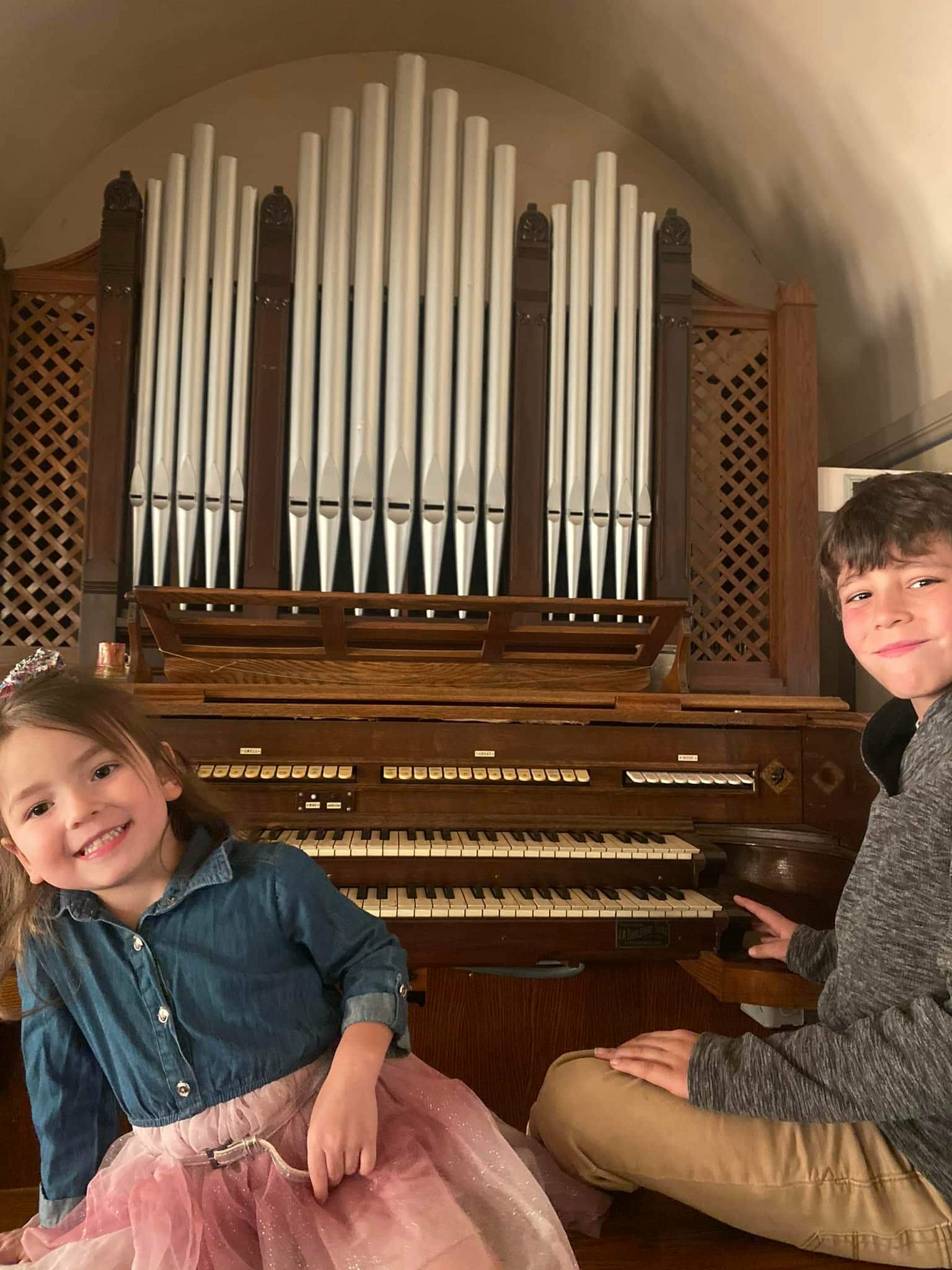 Young people discovering the historic 1927 pipe organ at the Rose Garden Center for the Arts